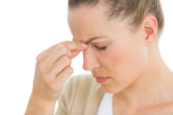 Woman pinching the bridge of her nose