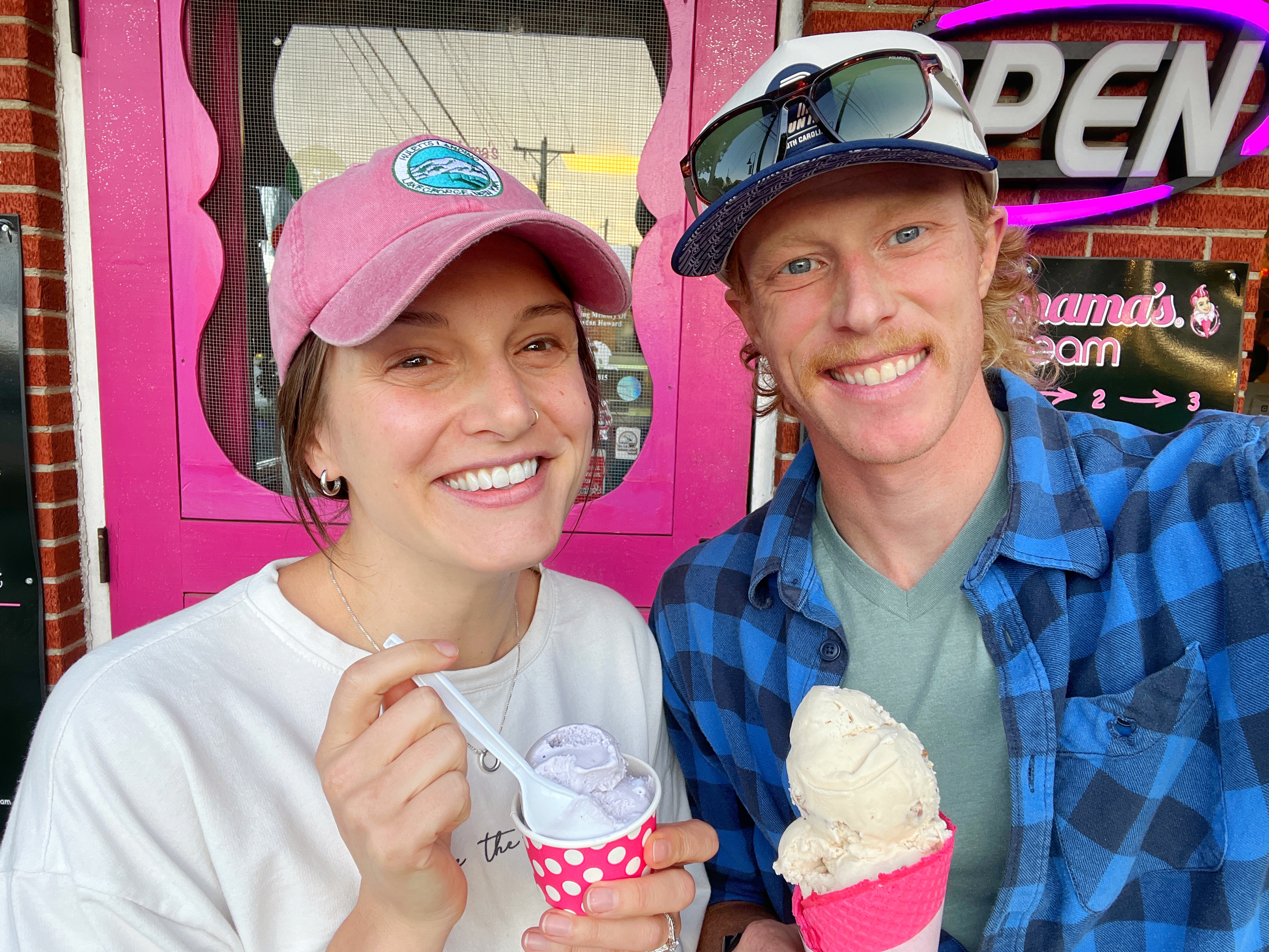 Joanna and her husband smiling while eating ice cream from a local shop